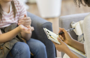 Getty Images-1026754404-teen-talks-to-doctor